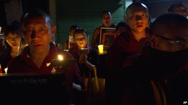 Tibetan exiles participate in a candlelit vigil in Dharmsala, India, Sunday, Sept. 30, 2012.