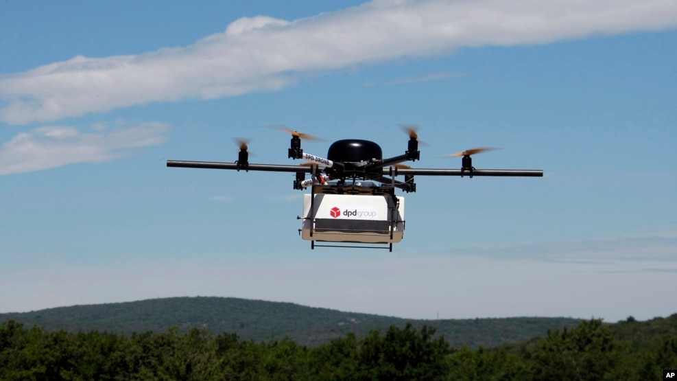 FILE - A prototype drone is seen carrying a parcel for delivery. As drones quickly pick up momentum around the world in everything from military strikes to pizza delivery, Africa, the continent with some of the most entrenched humanitarian crises, hopes the technology will bring progress.