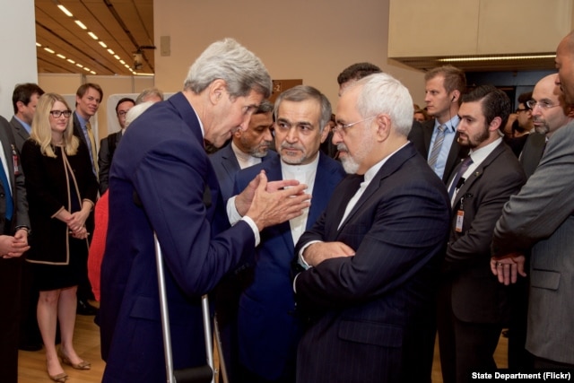 U.S. Secretary of State John Kerry speaks with Hossein Fereydoun, the brother of Iranian President Hassan Rouhani, and Iranian Foreign Minister Javad Zarif, in Vienna, Austria, July 14, 2015.