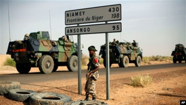 French armored vehicles are seen heading towards the Niger border before making a left turn north in Gao, northern Mali,  Feb. 6, 2013