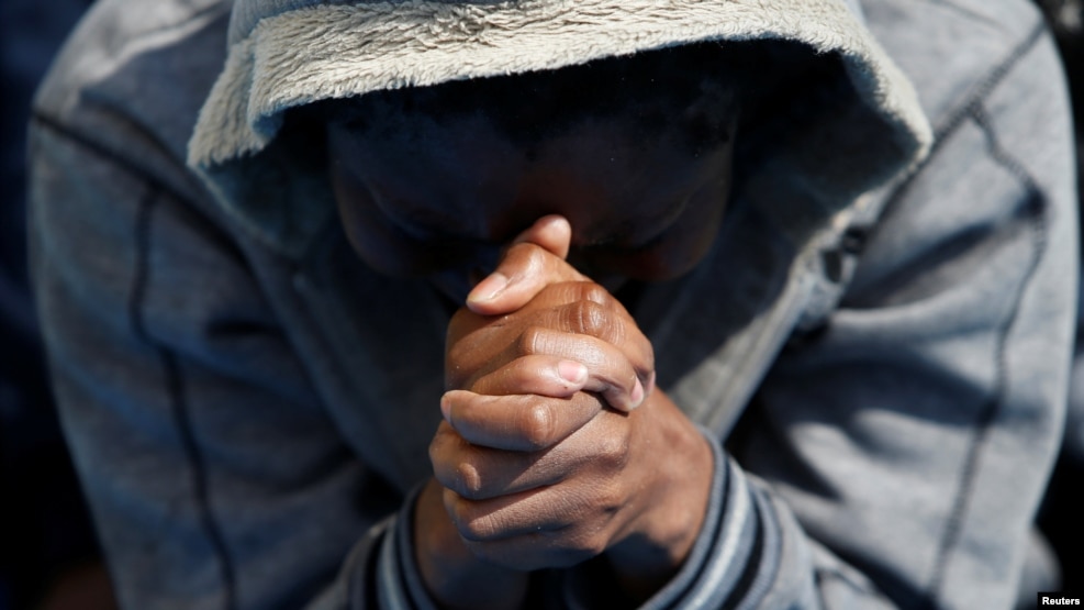 A migrant prays on the Migrant Offshore Aid Station ship Topaz Responder after being rescued around 20 nautical miles off the coast of Libya, June 23, 2016.