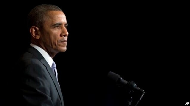 President Barack Obama pauses during speech at the general session of the Democratic National Committee meeting, Washington, Feb. 28, 2014.