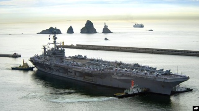 The aircraft carrier USS George Washington (CVN 73) departs Busan, Republic of Korea, 25 July 2010