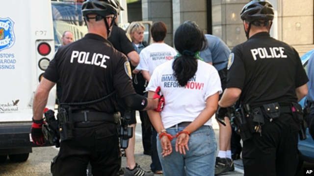Seattle Police arrest a protester for obstructing traffic during a rally to demand comprehensive immigration reform, 23 June 2010