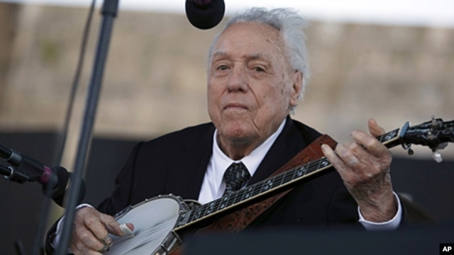 FILE - In this July 30, 2011 file photo, Earl Scruggs performs at the Newport Folk Festival in Newport, Rhode Island.  Scruggs performed at the original festival 52 years ago. 