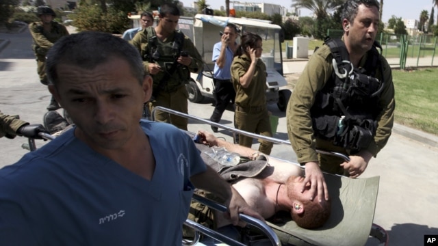 An injured Israeli soldier is wheeled into Soroka hospital in the southern town of Beersheva, Israel, following an exchange of fire with militants along Israel's southern border with Egypt, September 21, 2012.