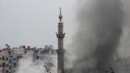 Smoke rises from a mosque and another building during heavy fighting in the Jobar area of Damascus Feb. 6, 2013. (Reuters)