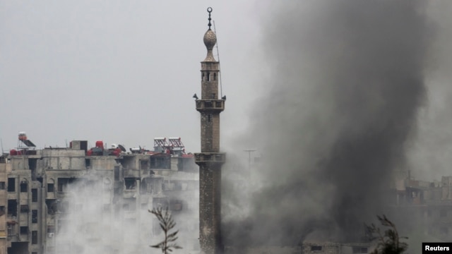 Smoke rises from a mosque and another building during heavy fighting between the Free Syrian Army and President Bashar al-Assad's forces, in the Jobar area of Damascus Feb. 6, 2013. 