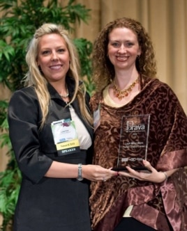 Layli Miller-Muro, (right), executive director of the Tahirih Justice Center, receives a 2010 BRAVA! Women Business Achievement Award.