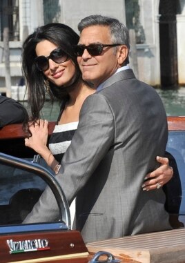 George Clooney and his fiancee Amal Alamuddin arrive in Venice, Italy, Sept. 26, 2014.