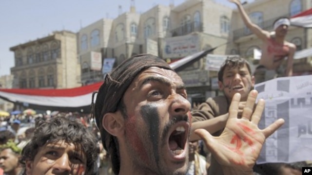 Anti-government protesters shout slogans during a rally to demand the ouster of Yemen's President Ali Abdullah Saleh outside Sanaa University, March 24, 2011