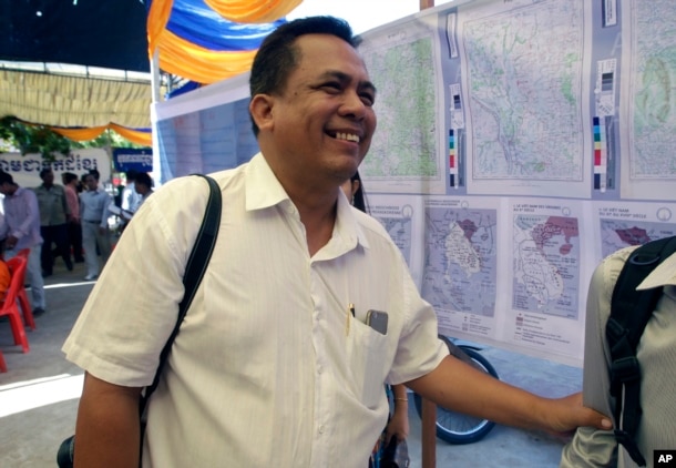 In this June 4, 2016, photo, prominent political analyst Kem Ley smiles as he celebrated the 67th anniversary to commemorate the Kampuchea Krom territory's return to Vietnam by the French government, at Chroy Changvar, in Phnom Penh, Cambodia.