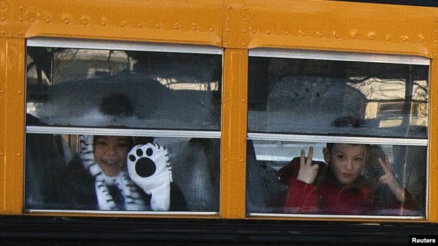 Children from Sandy Hook Elementary School make their way to their new school in Monroe as they leave Newtown, Connecticut, January 3, 2013.