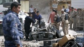 Security forces inspect the scene of a car bomb attack in Basra, 550 kilometers southeast of Baghdad, Iraq, Sunday, Sept. 9, 2012. 