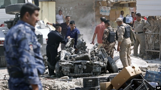 Security forces inspect the scene of a car bomb attack in Basra, 550 kilometers southeast of Baghdad, Iraq, Sunday, Sept. 9, 2012. 