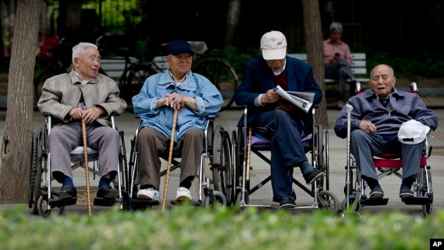 A group of elderly men take a rest on their wheelchairs at a park in Beijing, (File photo).