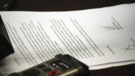 Ethiopia's minister of justice, unseen, reads aloud from a document appearing to be a petition for mercy by two Swedish journalists who have been imprisoned in Ethiopia,  Sept. 10, 2012.