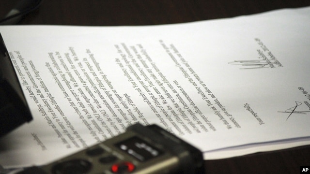 Ethiopia's minister of justice, unseen, reads aloud from a document appearing to be a petition for mercy by two Swedish journalists who have been imprisoned in Ethiopia,  Sept. 10, 2012.