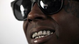 Recording artist Lil Wayne talks during an interview at the opening of a new skateboard park he helped finance along with Glu Agency and Mountain Dew, in the Lower Ninth Ward of New Orleans, Sept. 26, 2012.