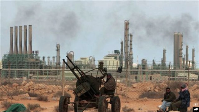 Rebels take their position in front the refinery oil complex, in Ras Lanouf town, eastern Libya, March 10, 2011