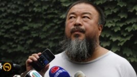 Chinese dissident artist Ai Weiwei listens as his lawyer announces over speakerphone the verdict of Ai's lawsuit against the tax authorities in Beijing, July 20, 2012.