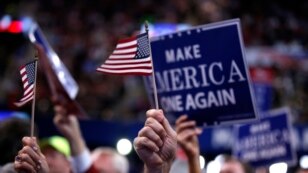 Delegates wave signs and flags during the final day of the Republican National Convention in Cleveland, July 21, 2016. 
