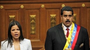 A daughter of the late Hugo Chavez, Maria Gabriela Chavez and Venezuela's newly sworn-in President Nicolas Maduro join in the singing of their national anthem in the National Assembly, in Caracas, Venezuela, April 19, 2013. 