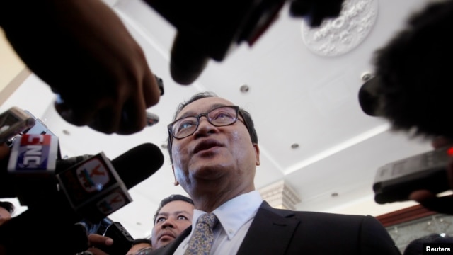 FILE - Sam Rainsy, President of the Cambodia National Rescue Party (CNRP), speaks to media after a meeting at the National Assembly in central Phnom Penh.