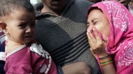 Relatives mourn the death of a garment worker after a fire consumed a garment factory in Savar, Bangladesh, November 25, 2012.