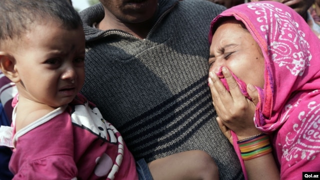 Relatives mourn the death of a garment worker after a fire consumed a garment factory in Savar, Bangladesh, November 25, 2012.
