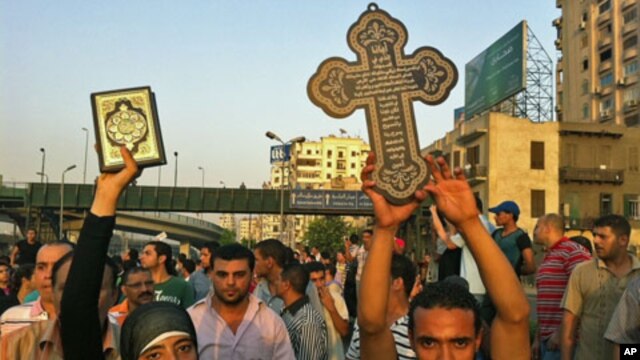 A Muslim woman holds a Quran during a show of solidarity with protesting Coptic Christians, Cairo, Egypt. October 10, 2011.