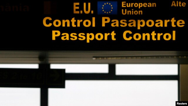 FILE - An EU sign is seen in the passport control area at Bucharest's Henri Coanda International Airport, Jan. 1, 2007. Many Turks are hoping a just concluded refugee deal with Brussels will eventually offer them visa-free travel in the EU.