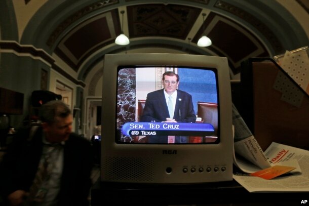 FILE - Sen. Ted Cruz, R-Texas, is seen on a television in the Senate Press Gallery as he speaks during the seventh hour of his filibuster on the Senate floor at the U.S. Capitol in Washington, D.C., Sept. 24, 2013.