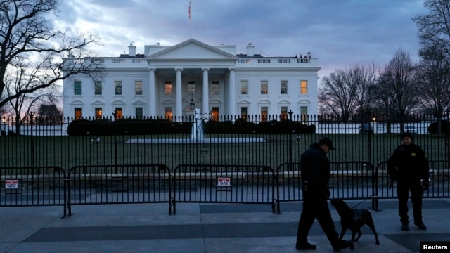 FILE - Secret Service Uniformed Division officers patrol in front of the White House, Washington, D.C., Jan. 20, 2015.