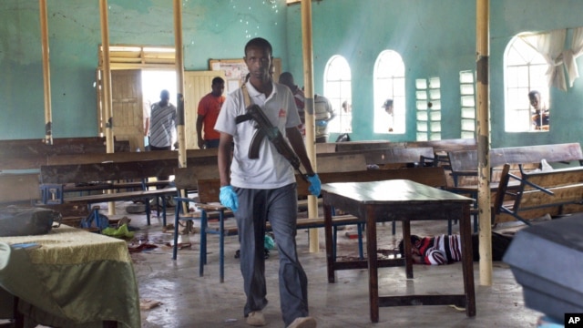 An armed Kenyan policeman walks inside the African Inland Church in Garissa, July 1, 2012. 