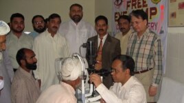 Dr. Ghulam Hussain Asif examines patients during a free clinic.