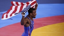 Jordan Burroughs of U.S. celebrates after defeating Iran's Sadegh Saeed Goudarzi in the final of the men's 74Kg freestyle wrestling at the ExCel venue during the London 2012 Olympic Games, August 10, 2012.