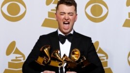Sam Smith poses with his awards including one for Best New Artist.