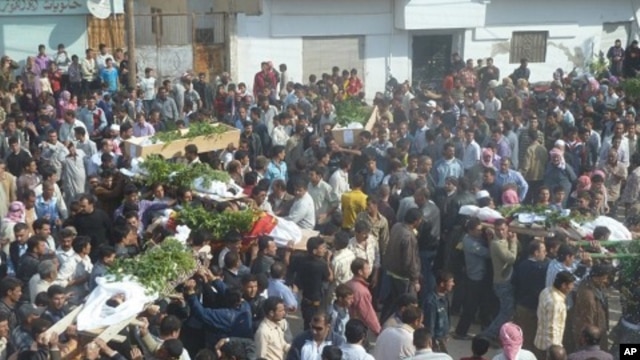Anti-government protesters carry the coffins of Sunni Muslim villagers killed on Wednesday, in Hula near Homs, November 2, 2011.