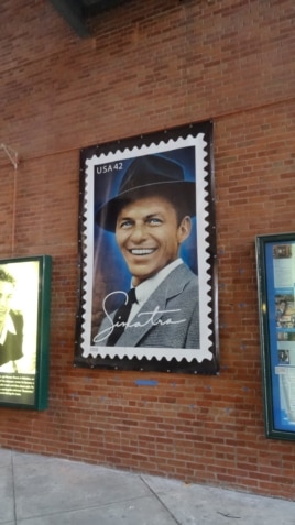 A poster of a US postage stamp depicting Frank Sinatra is seen on Dec. 8, 2015 at the entrance of the Hoboken Historical Museum in Hoboken, New Jersey.