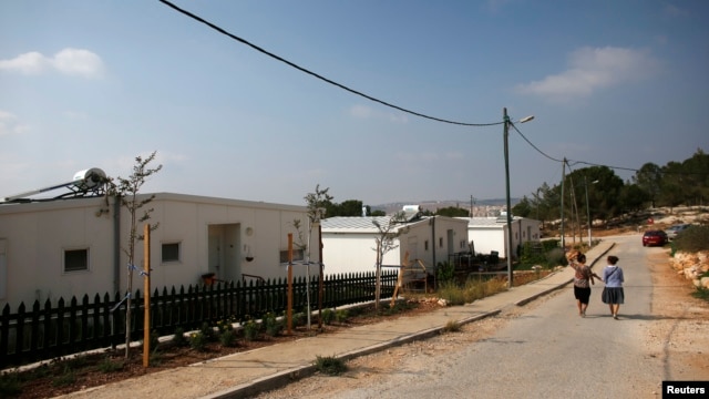 Israeli women walk in a Jewish settlement known as "Gevaot" - in the Etzion settlement bloc - near Bethlehem, Aug. 31, 2014.