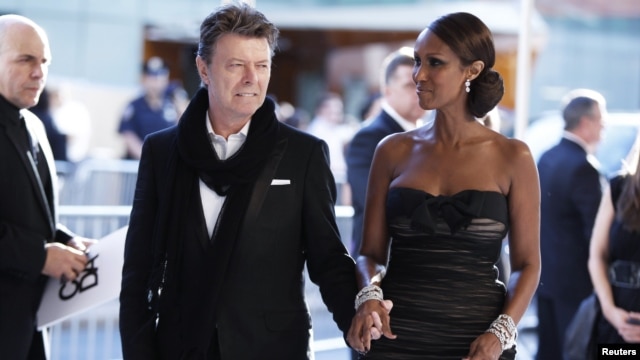 FILE - David Bowie arrives with his wife Iman to attend the CFDA fashion awards in New York, June 7, 2010.