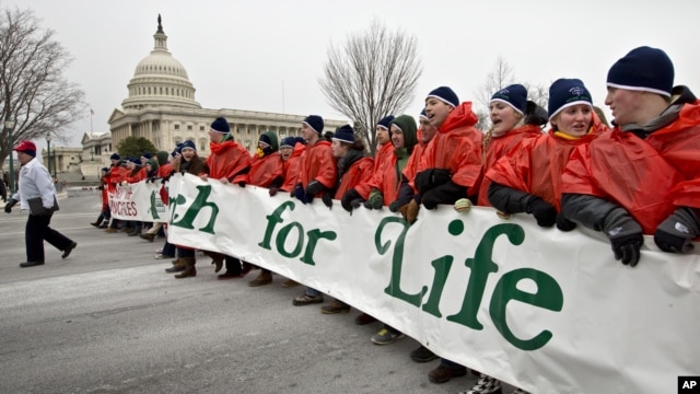 Anti-abortion activists march past the Capitol in Washington, Friday, Jan. 25, 2013, to the Supreme Court as they observe the 40th anniversary of the Roe v. Wade decision.