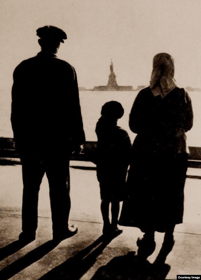 An immigrant family views the Statue of Liberty from Ellis Island