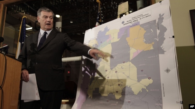 Dallas Mayor Mike Rawlings points to a map showing Dallas County and the aerial spraying against mosquitos during a news conference in Dallas, Aug. 17, 2012.