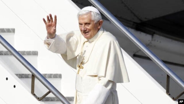 Pope Benedict XVI waves as he boards his plane to leave for his pastoral visit to Mexico and Cuba, at Fiumicino International Airport in Rome, March 23, 2012. 
