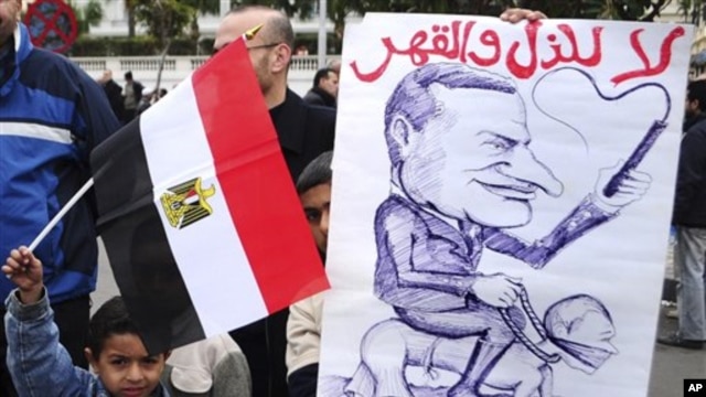 Egyptian children hold an anti-Mubarak cartoon during a protest in Alexandria, Egypt, February 4, 2011