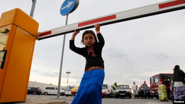 A member of Romania's ethnic Roma minority arrives at Bucharest airport, Aug. 9, 2012. 