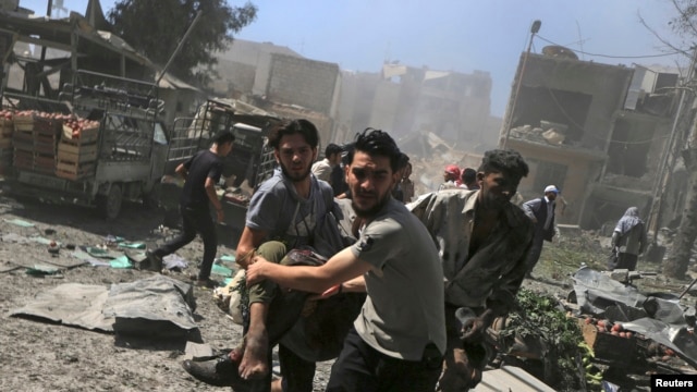 FILE - Men transport a casualty after what activists said were airstrikes by forces loyal to Syria's President Bashar al-Assad on a busy marketplace in Douma, near Damascus, Syria, Aug. 12, 2015. 