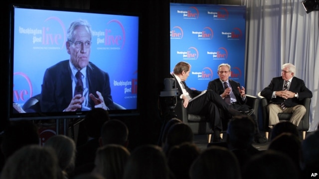 Former Washington Post reporter Bob Woodward, is seen on the monitor as moderator Charlie Rose, left, Woodward and Bernstein speak during an event to commemorate the 40th anniversary of Watergate, June 11, 2012.